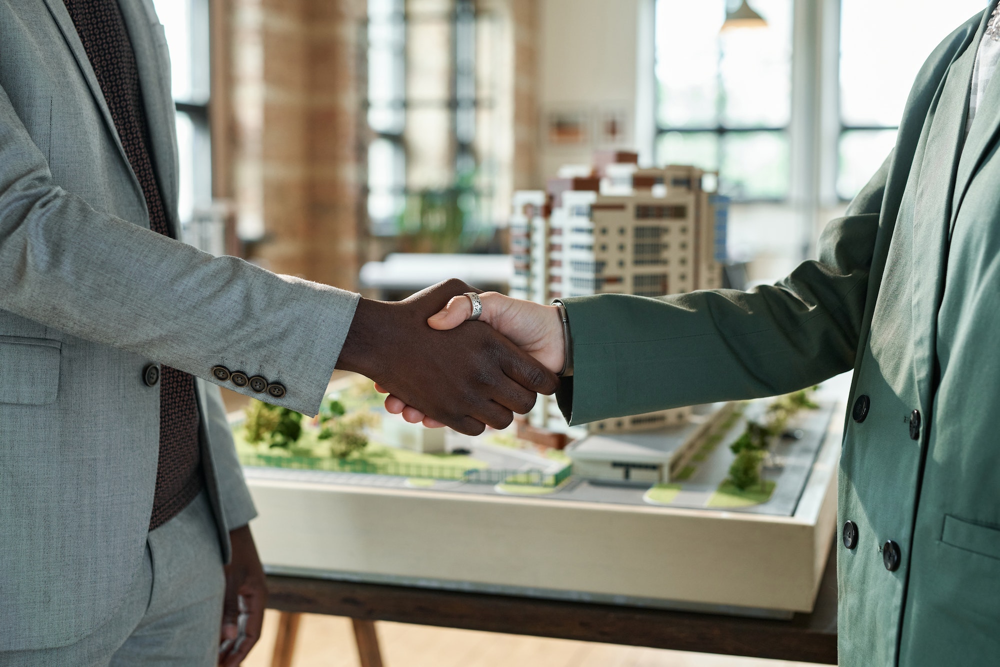 Architects shaking hands at meeting
