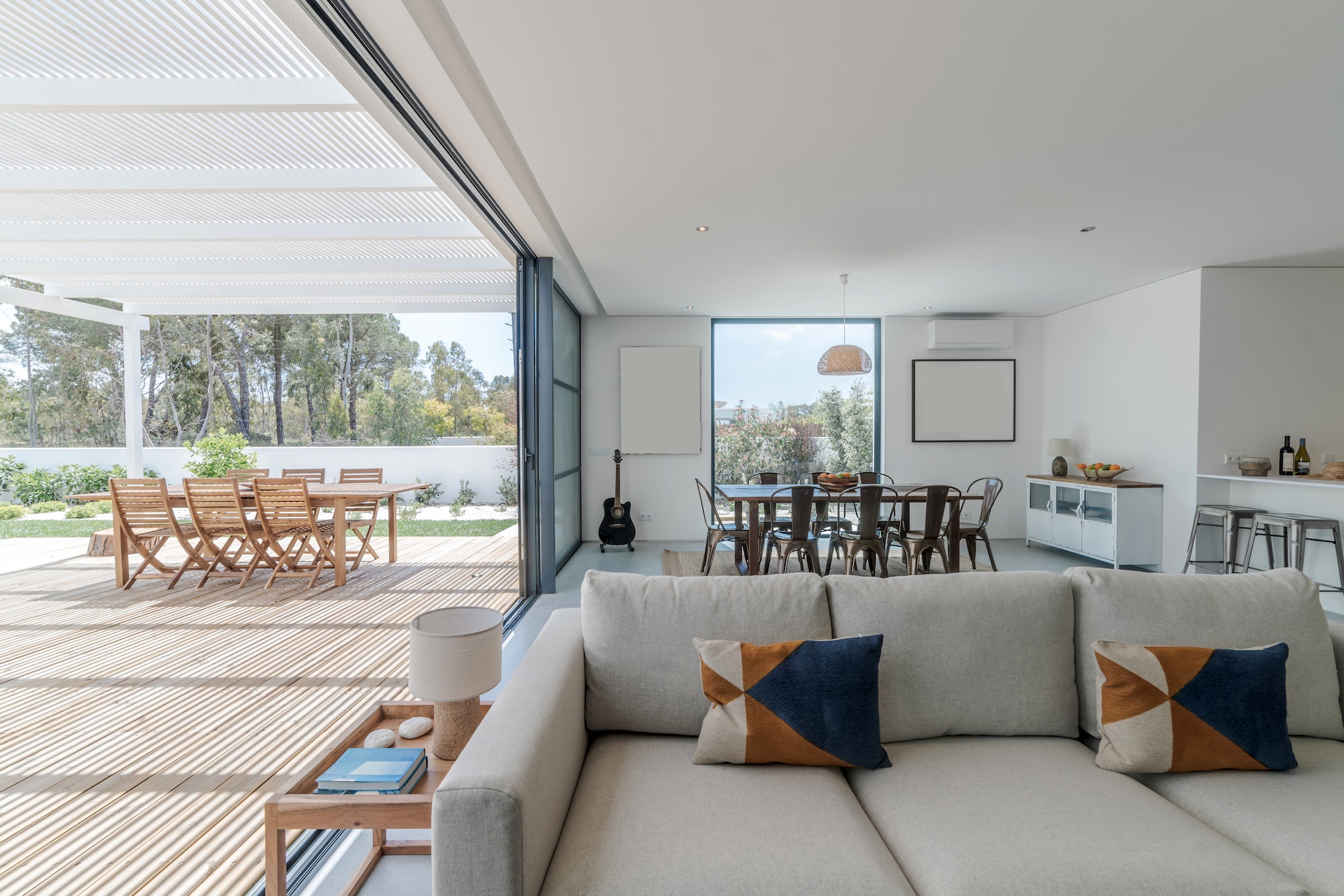 Living room in modern villa with and deck outside